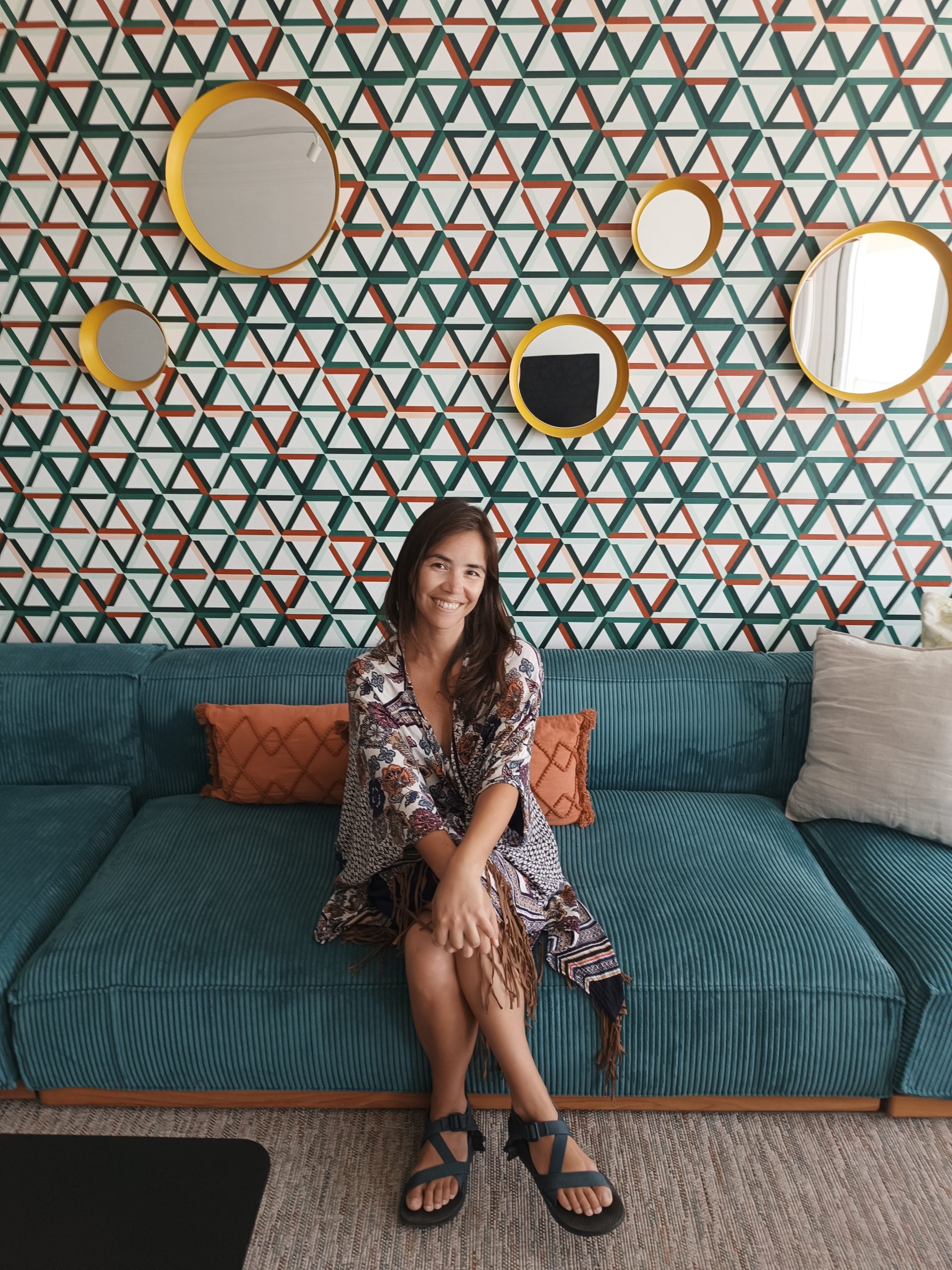 Shayna Grajo smiling, seated on a teal couch in Estepona, Spain, July 2026